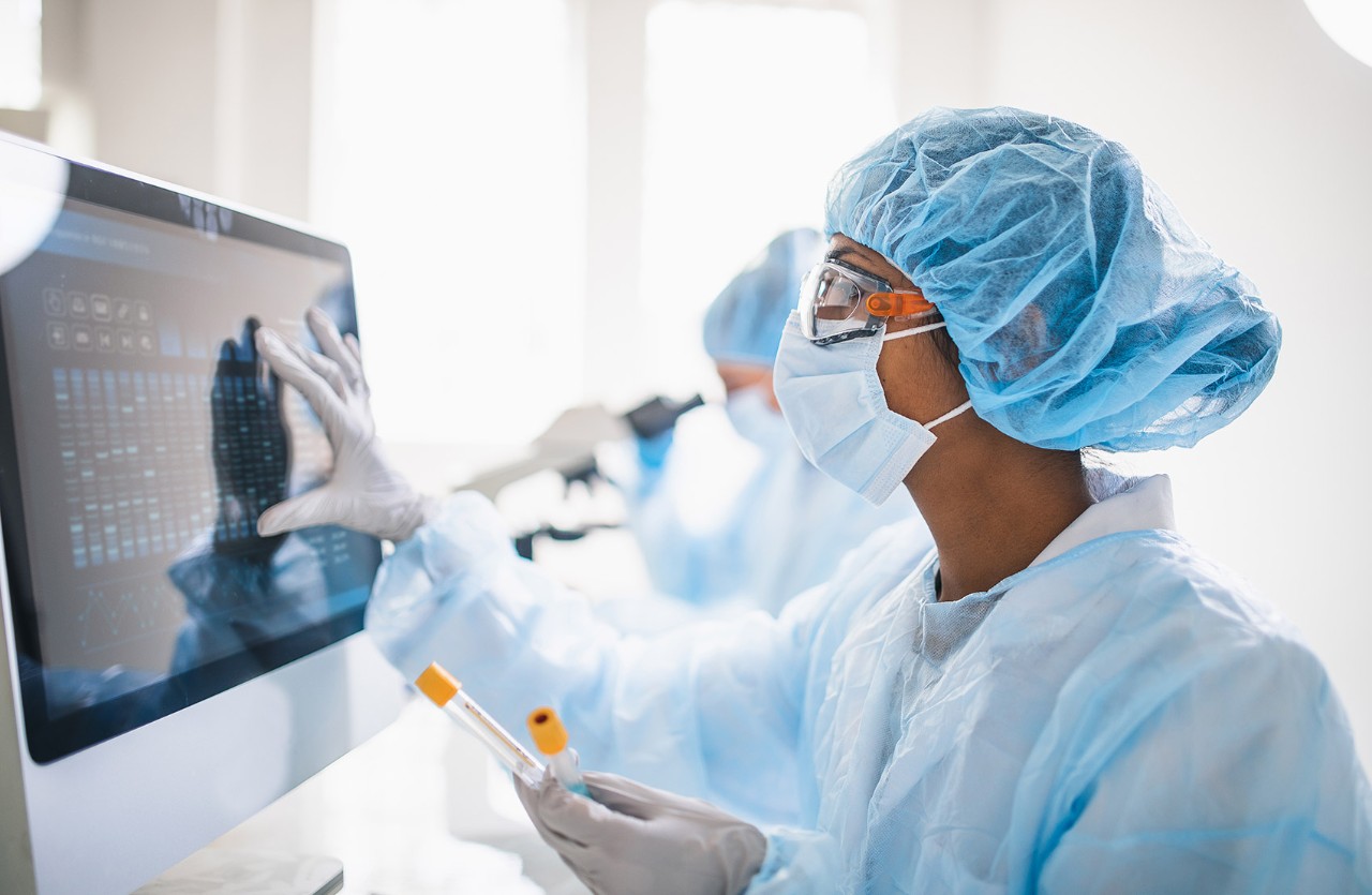 Scientists wearing full protective suit working in the laboratory