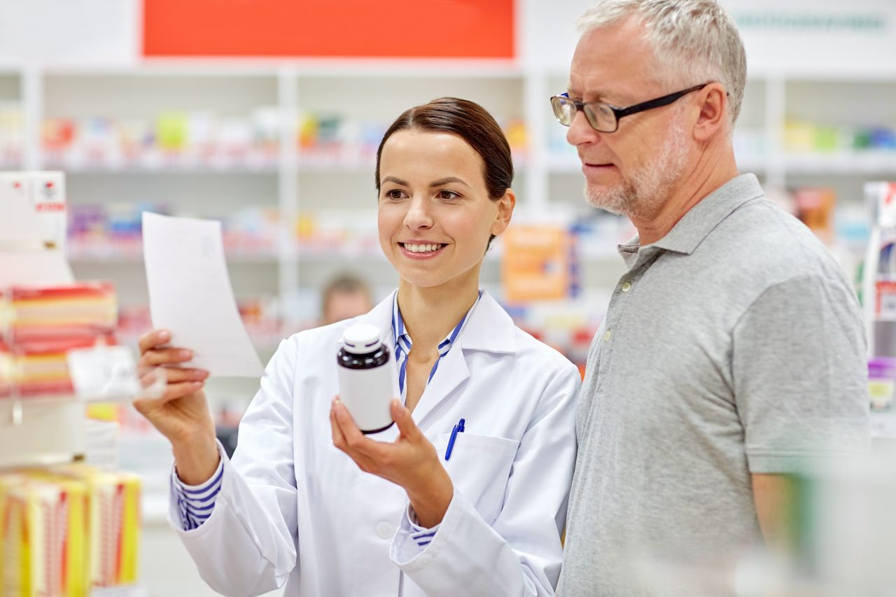 Patient at a pharmacy, talking to a pharmacist