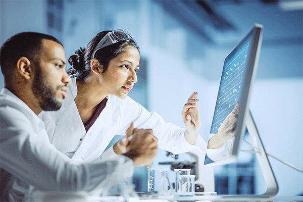 Two scientists looking at computer screen